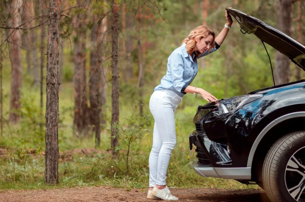 beautiful woman checking front of car